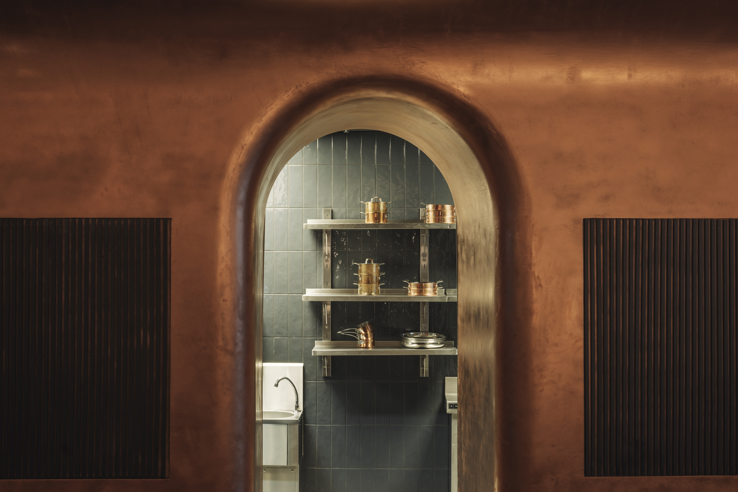 The copper clad doorway that leads into the Le Petit Bon Bon kitchen.