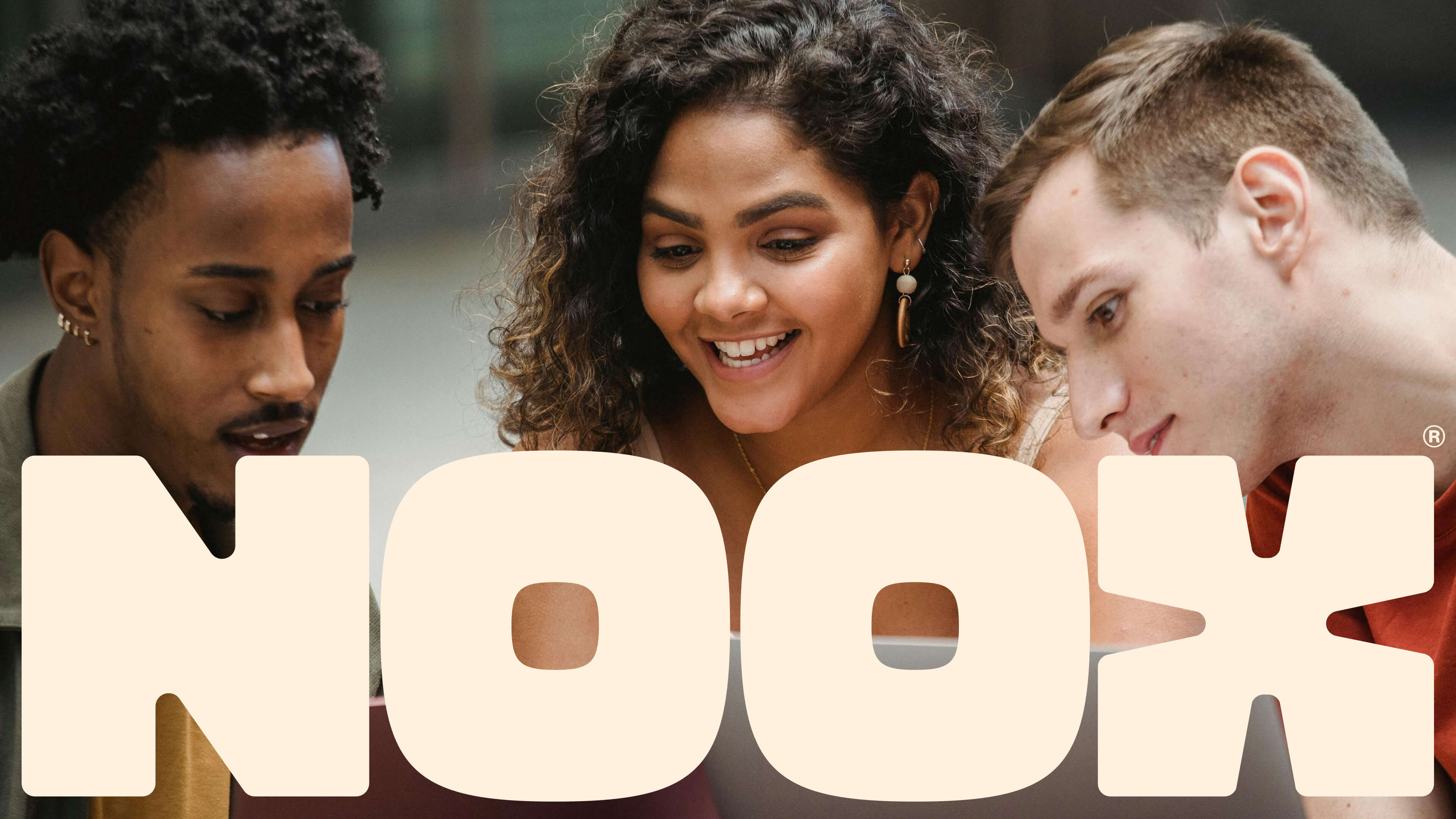 People looking at the letters in the word Noox.