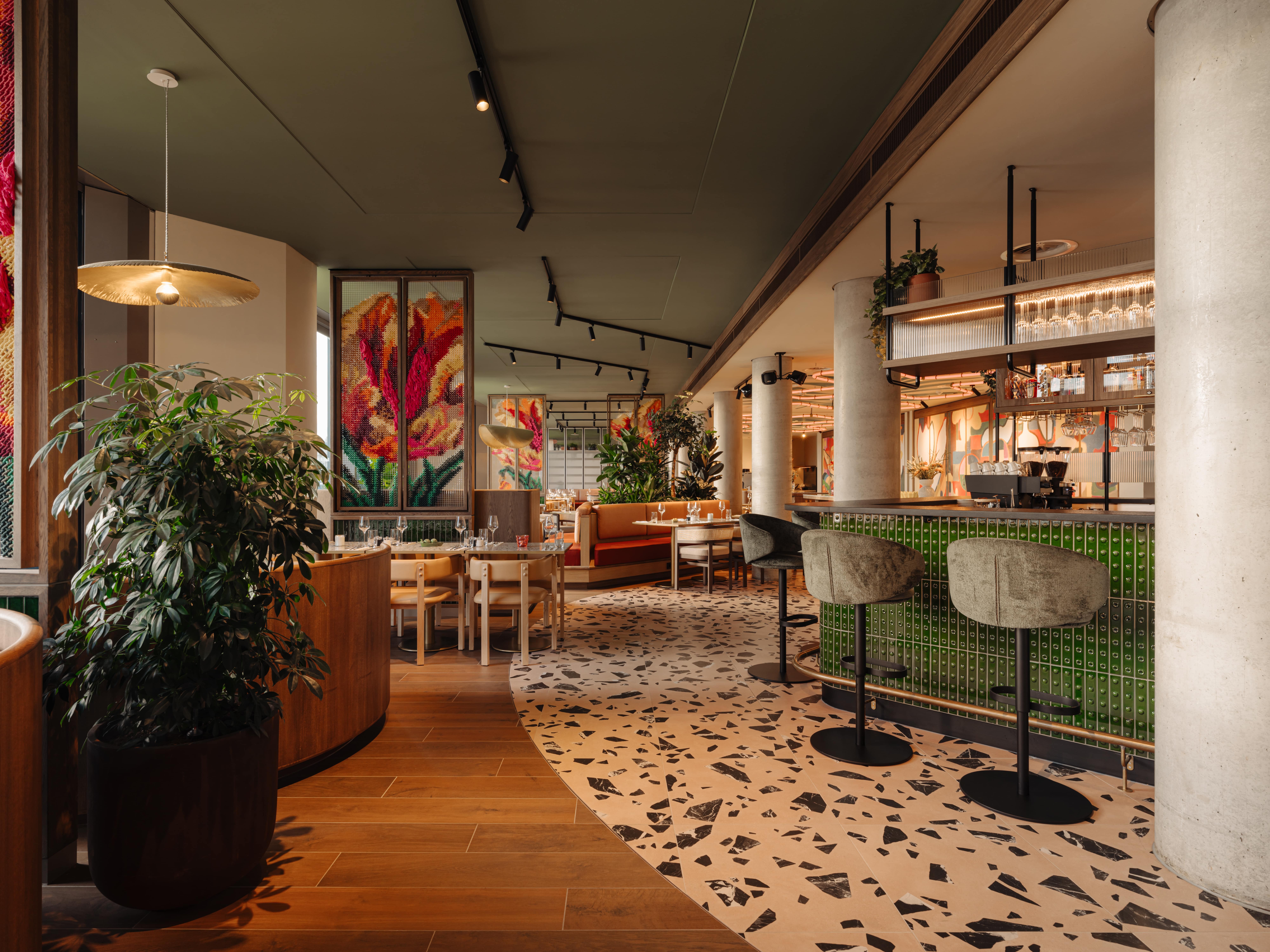 A view of the restaurant's wooden floor and tile bar.