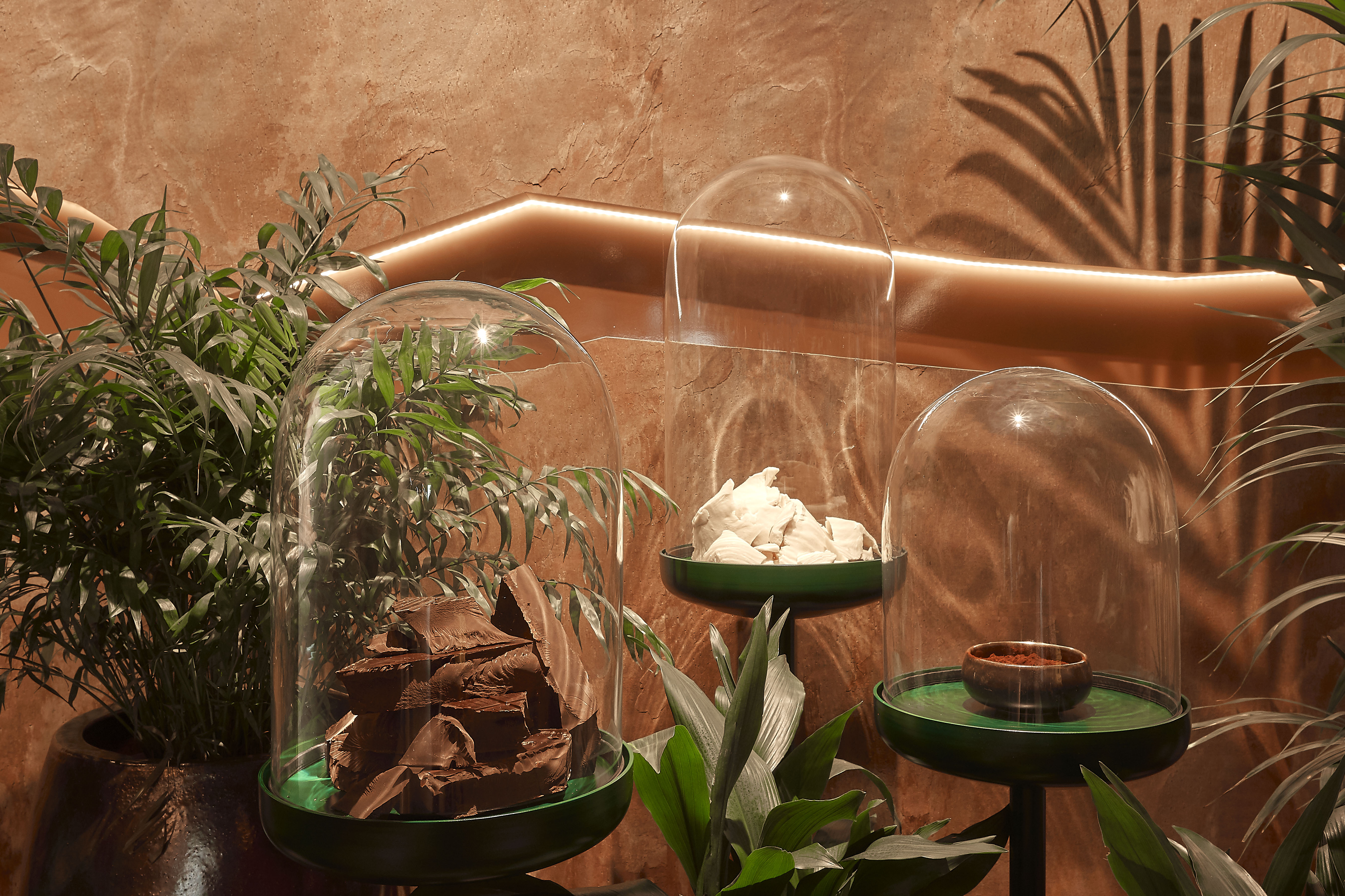 Large glass domes with pieces of chocolate inside.
