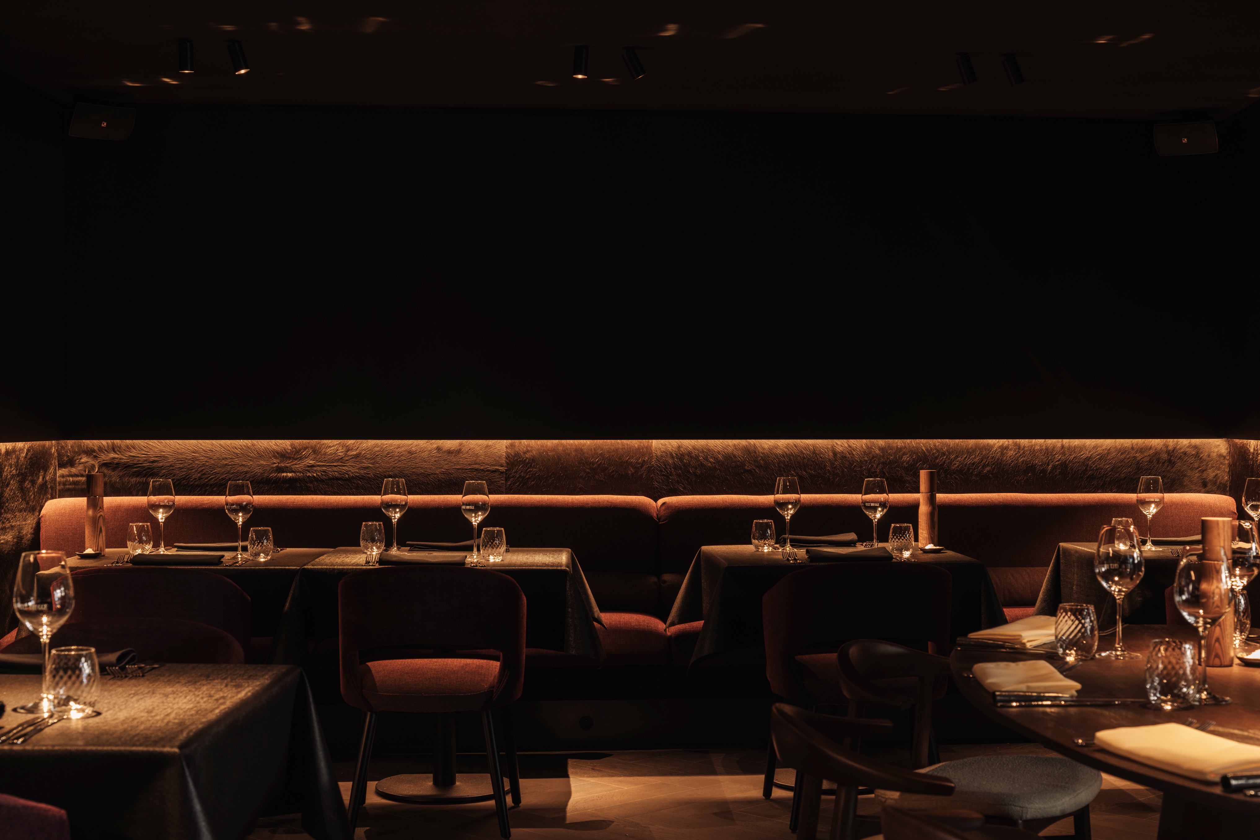 Deep burgundy furniture mirrors the lush tones of fine wine in the seating area.